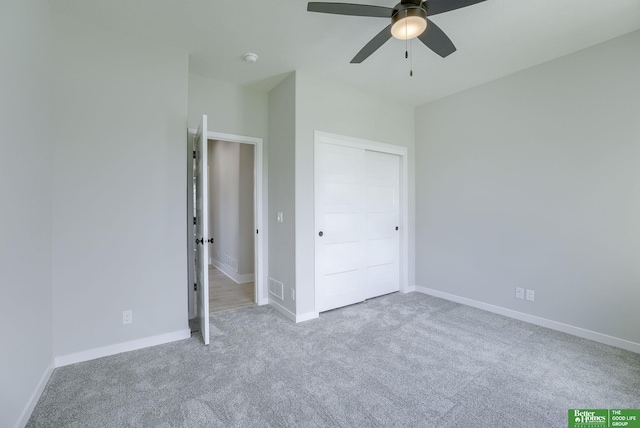 unfurnished bedroom featuring a closet, baseboards, visible vents, a ceiling fan, and carpet floors