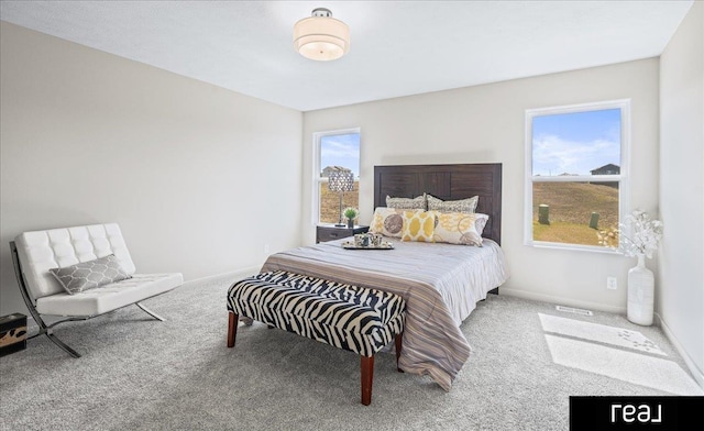 bedroom featuring baseboards, multiple windows, and carpet flooring