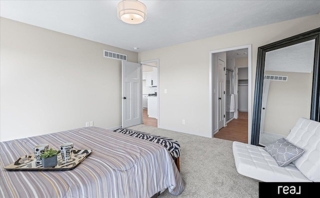 bedroom featuring carpet flooring, visible vents, and baseboards