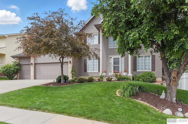 6520 N 157th St, Omaha, NE 68116 - view of front facade with driveway, a front yard, and a garage