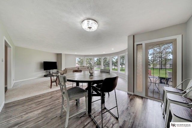 dining room with baseboards, recessed lighting, and wood finished floors