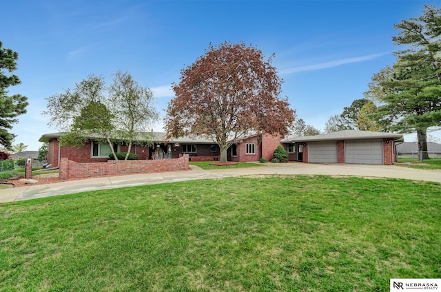 ranch-style home with a garage, driveway, a front lawn, and brick siding
