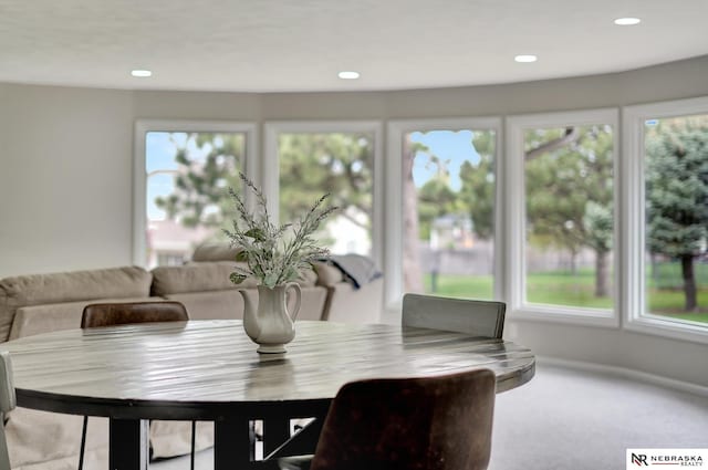 carpeted dining space featuring recessed lighting and a wealth of natural light