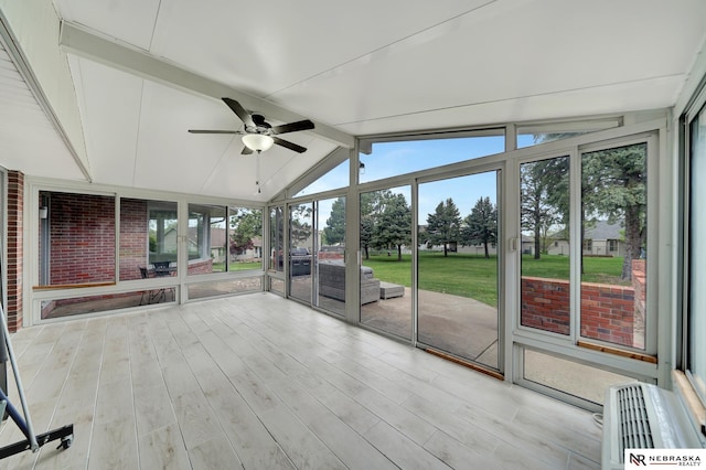 unfurnished sunroom featuring ceiling fan and beam ceiling