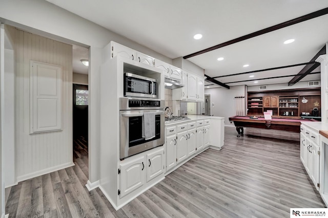 kitchen featuring appliances with stainless steel finishes, pool table, light wood-style flooring, light countertops, and white cabinetry