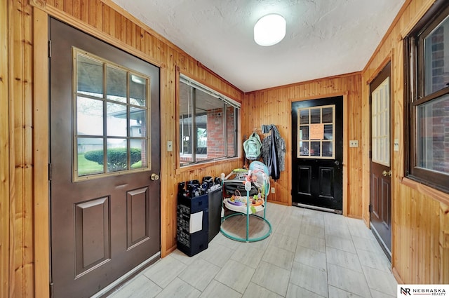 entryway with wood walls