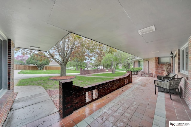 view of patio / terrace featuring fence