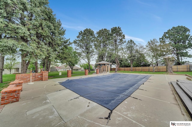 view of swimming pool featuring a fenced in pool, a gazebo, a fenced backyard, and a patio area