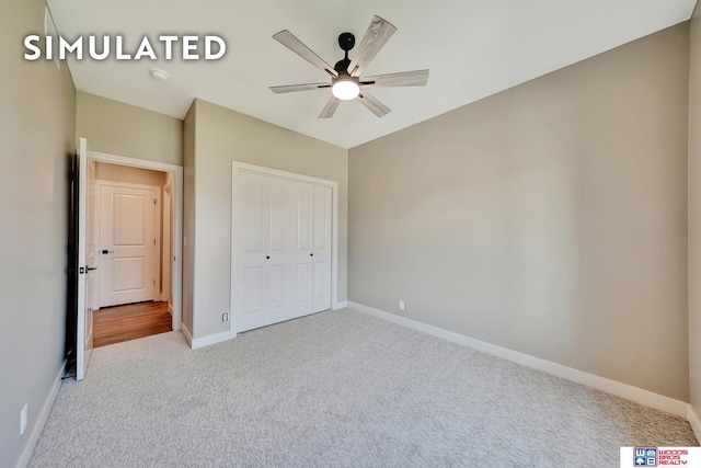 10551 Majestic Ln, Lincoln, NE 68527 - unfurnished bedroom with a closet, baseboards, a ceiling fan, and carpet floors