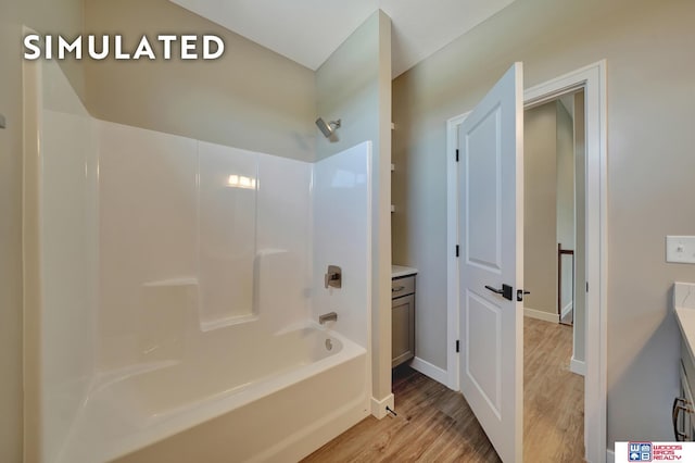 10551 Majestic Ln, Lincoln, NE 68527 - bathroom with wood finished floors, vanity, baseboards, and bathtub / shower combination