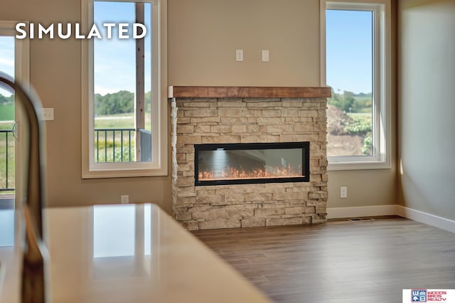 10551 Majestic Ln, Lincoln, NE 68527 - living room with wood finished floors, baseboards, and a stone fireplace