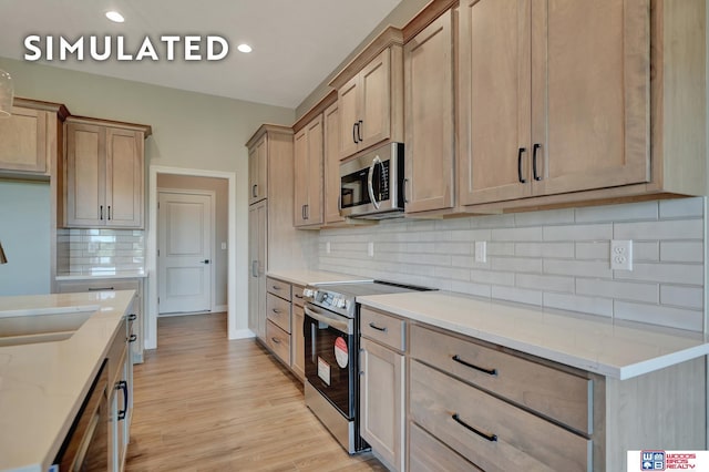 10551 Majestic Ln, Lincoln, NE 68527 - kitchen featuring tasteful backsplash, recessed lighting, a sink, stainless steel appliances, and light wood finished floors