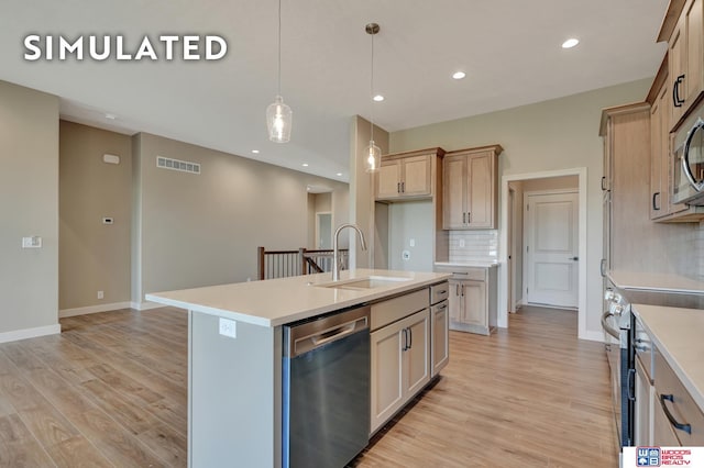 10551 Majestic Ln, Lincoln, NE 68527 - kitchen featuring visible vents, a sink, stainless steel appliances, light wood finished floors, and backsplash
