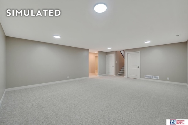 10551 Majestic Ln, Lincoln, NE 68527 - finished below grade area with carpet floors, baseboards, visible vents, and stairs