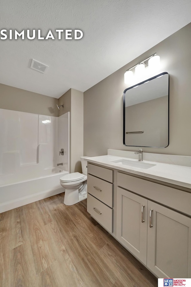 10551 Majestic Ln, Lincoln, NE 68527 - bathroom featuring vanity, toilet, visible vents, shower / bathing tub combination, and wood finished floors