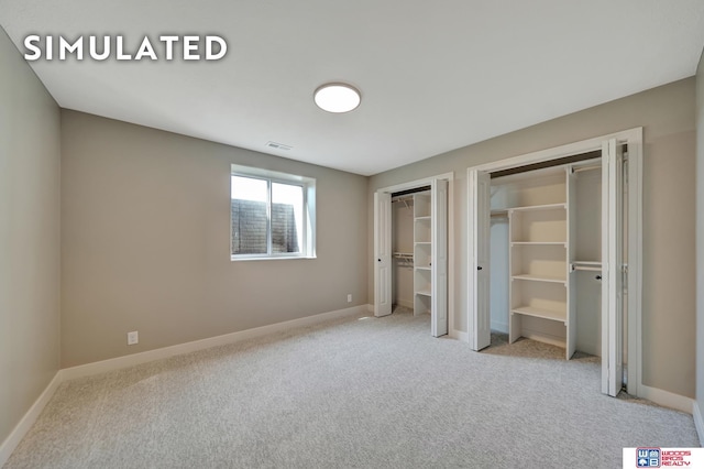 10551 Majestic Ln, Lincoln, NE 68527 - unfurnished bedroom with carpet floors, baseboards, two closets, and visible vents