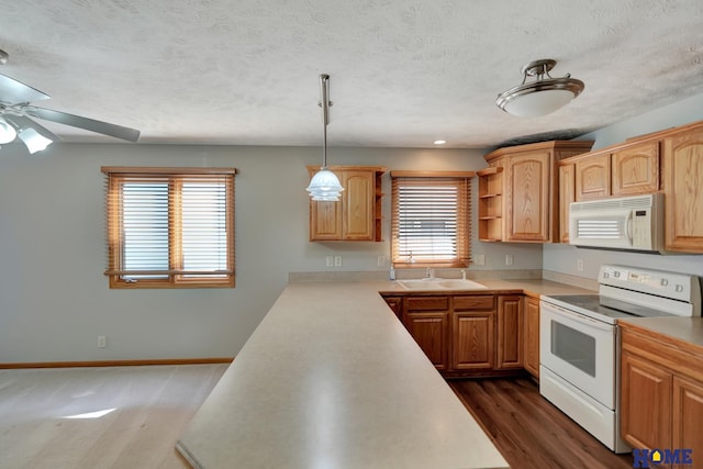 kitchen featuring white appliances, light countertops, a textured ceiling, open shelves, and a sink