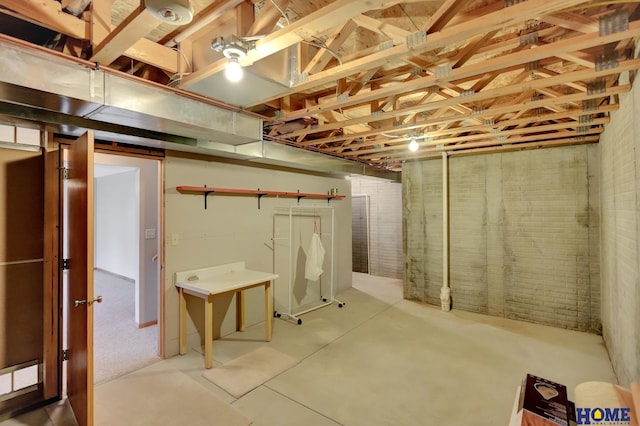 unfinished basement featuring brick wall