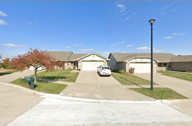 ranch-style house with a front yard, an attached garage, and driveway
