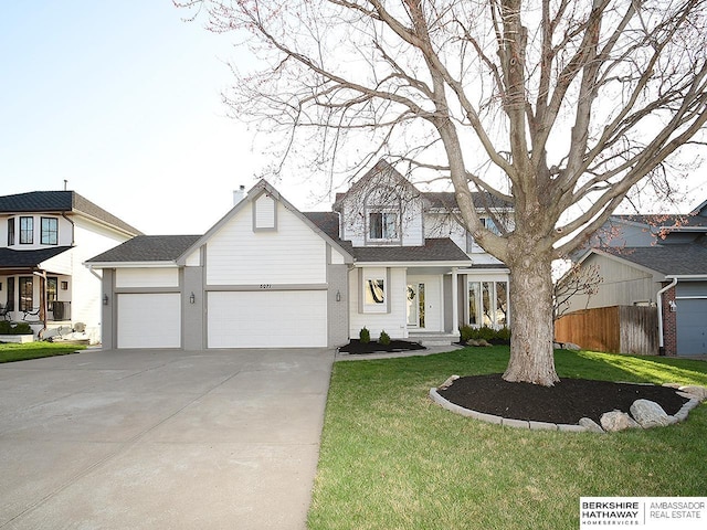 view of front of property featuring an attached garage, concrete driveway, fence, and a front lawn
