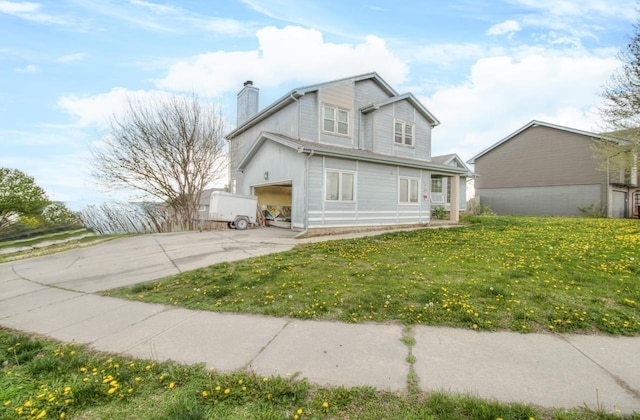 view of property exterior featuring a chimney, driveway, and a lawn