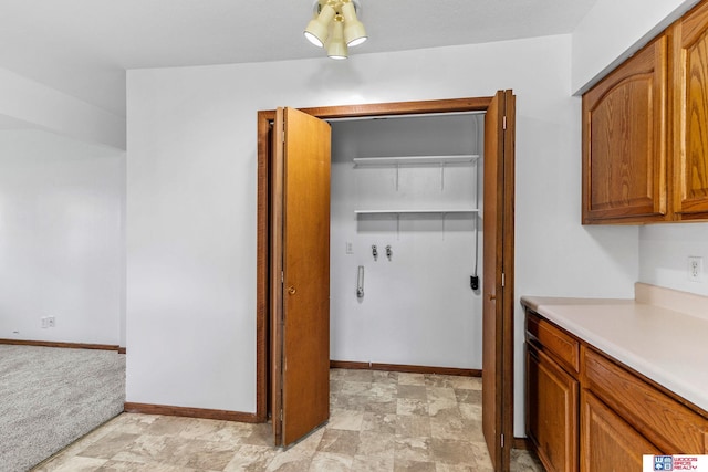 laundry room featuring baseboards, laundry area, and washer hookup