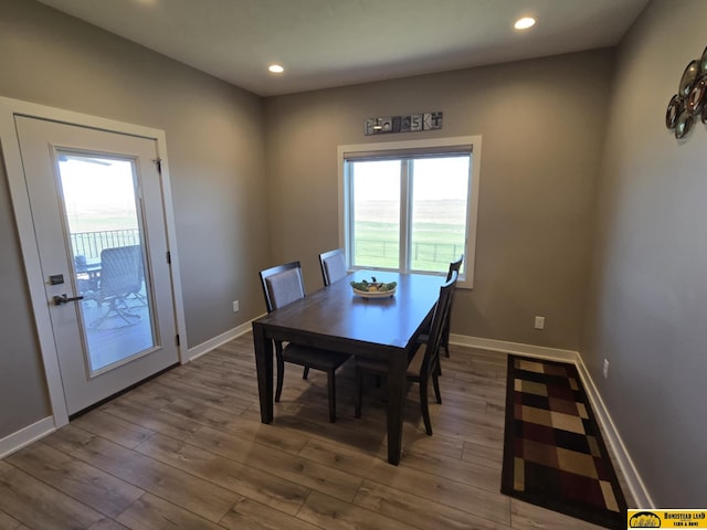 dining room with wood finished floors, baseboards, and recessed lighting