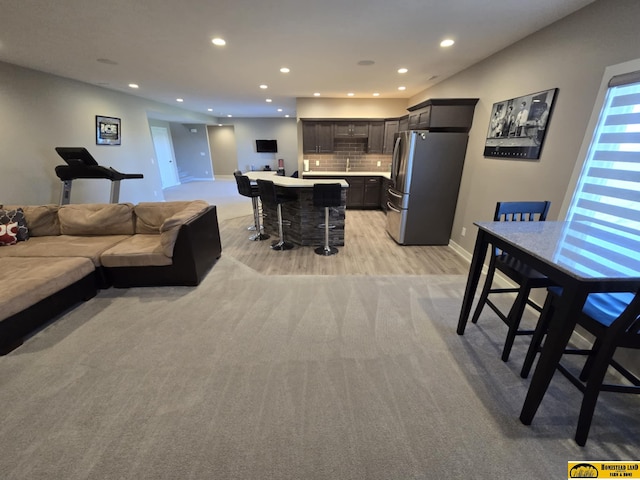 living area featuring baseboards and recessed lighting