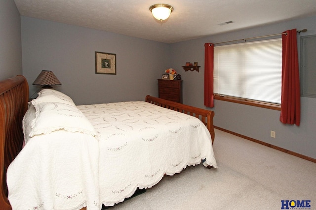 carpeted bedroom with visible vents and baseboards
