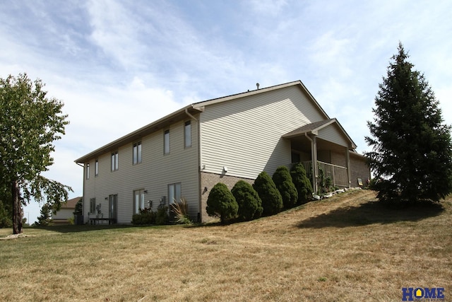view of property exterior featuring a yard and brick siding