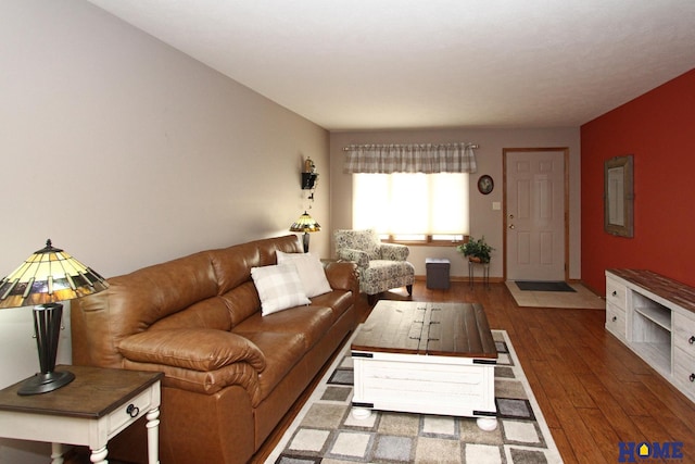 living area with baseboards and hardwood / wood-style flooring