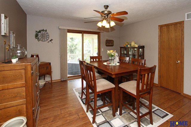 dining space with visible vents, baseboards, a ceiling fan, a textured ceiling, and light wood-style flooring