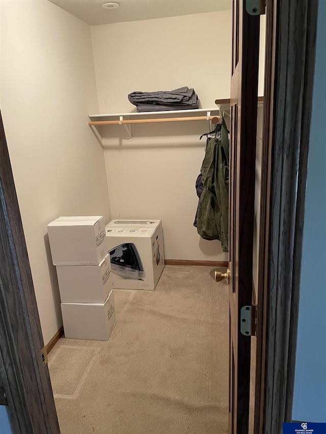walk in closet with carpet flooring
