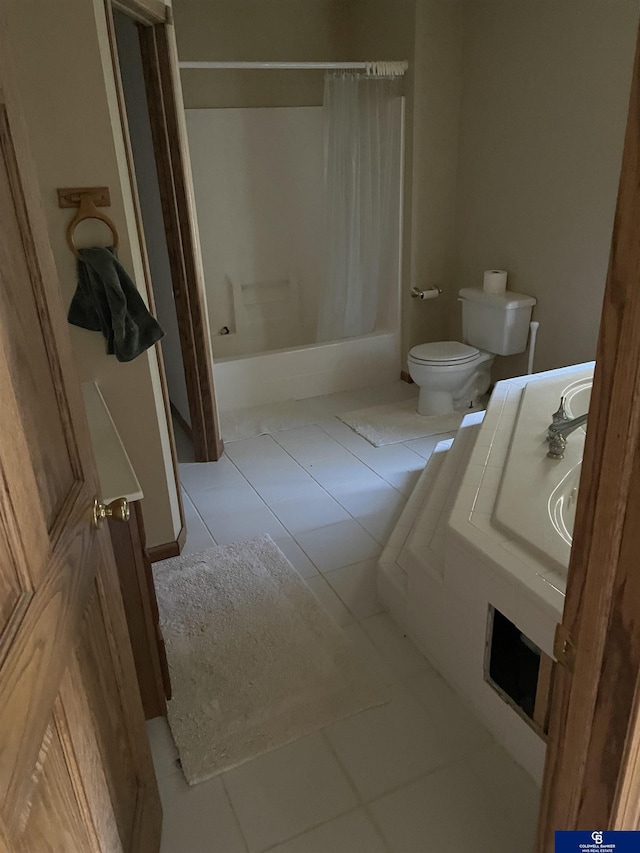 bathroom with shower / bathtub combination with curtain, tile patterned floors, and toilet