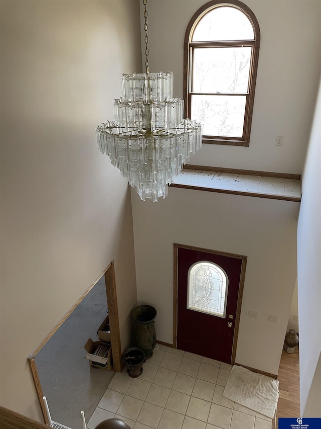 entryway featuring a chandelier and tile patterned floors