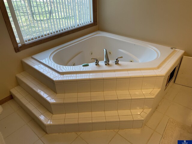 full bath with a whirlpool tub, tile patterned floors, and plenty of natural light