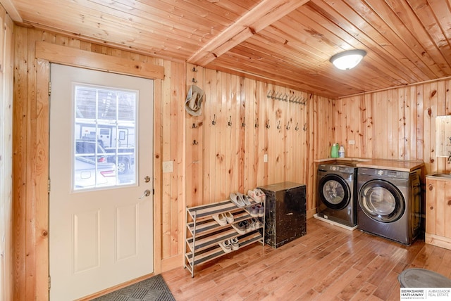 washroom with laundry area, wood ceiling, wood finished floors, wood walls, and washer and clothes dryer