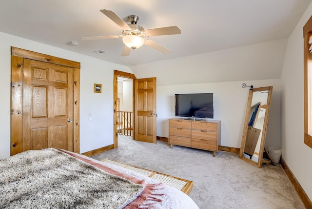 bedroom featuring baseboards, vaulted ceiling, visible vents, ceiling fan, and light colored carpet