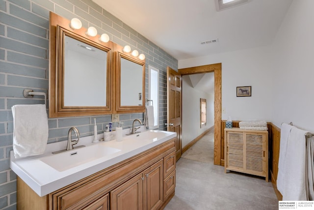 bathroom with a sink, visible vents, and double vanity