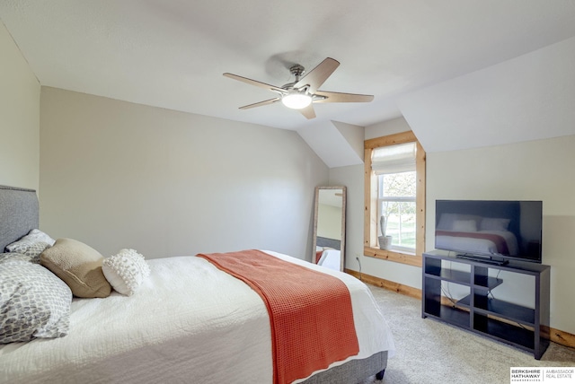 bedroom featuring light carpet, ceiling fan, baseboards, and vaulted ceiling