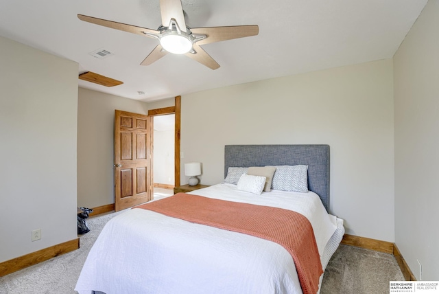 carpeted bedroom featuring baseboards, a ceiling fan, and visible vents