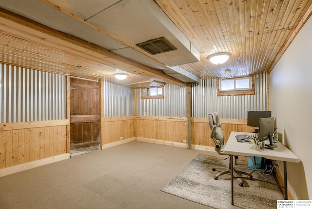 unfurnished office with carpet, visible vents, wood ceiling, wood walls, and baseboards