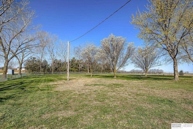 view of yard featuring fence and a rural view