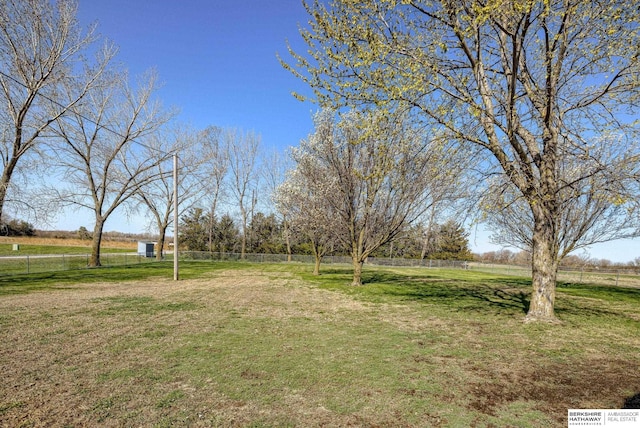 view of yard featuring a rural view and fence