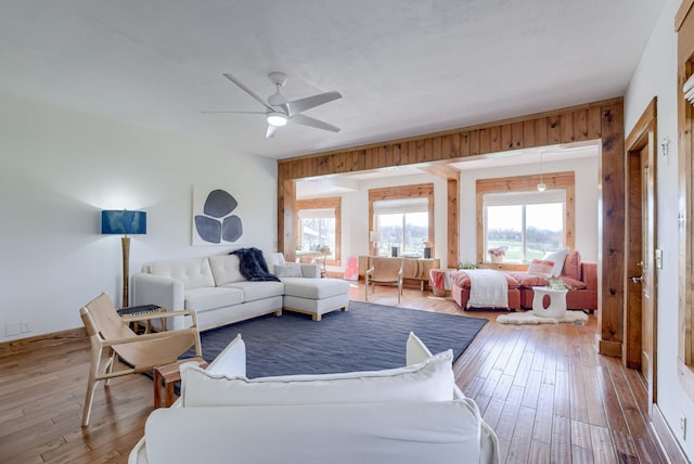 living room featuring hardwood / wood-style floors and ceiling fan