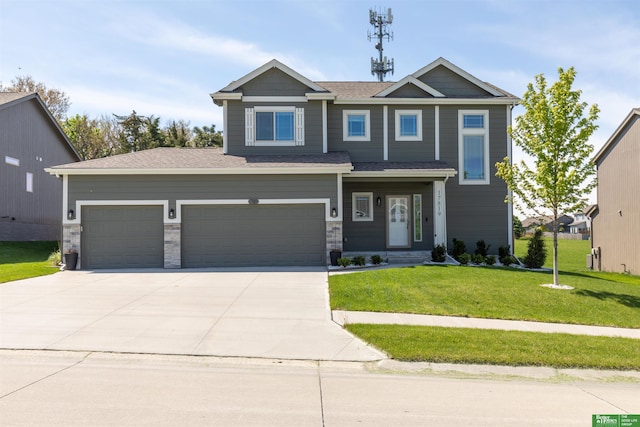 craftsman-style house with driveway, a front yard, an attached garage, and roof with shingles