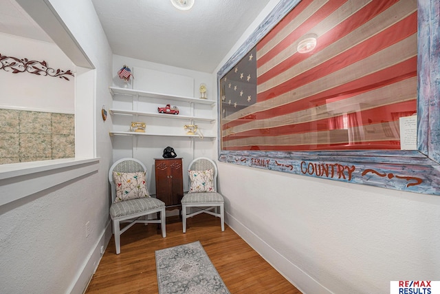 2860 335th St, Logan, IA 51546 - sitting room featuring baseboards and wood finished floors