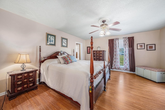 2860 335th St, Logan, IA 51546 - bedroom featuring ceiling fan, baseboards, wood finished floors, and a textured ceiling