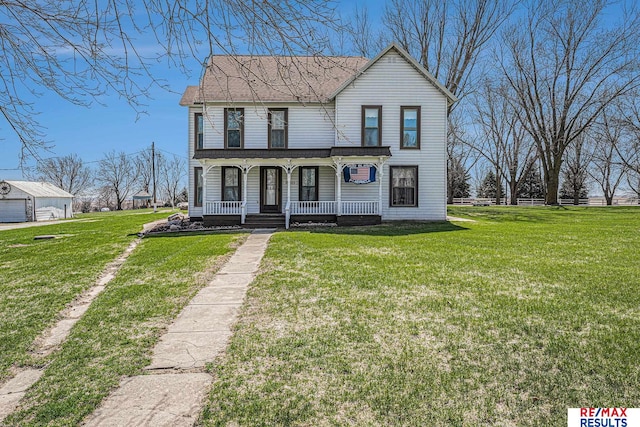 2860 335th St, Logan, IA 51546 - view of front facade with a porch, driveway, and a front lawn