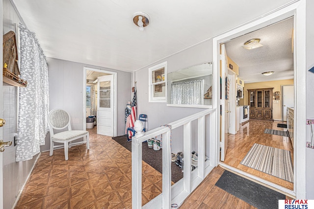 2860 335th St, Logan, IA 51546 - corridor featuring a textured ceiling and wood finished floors